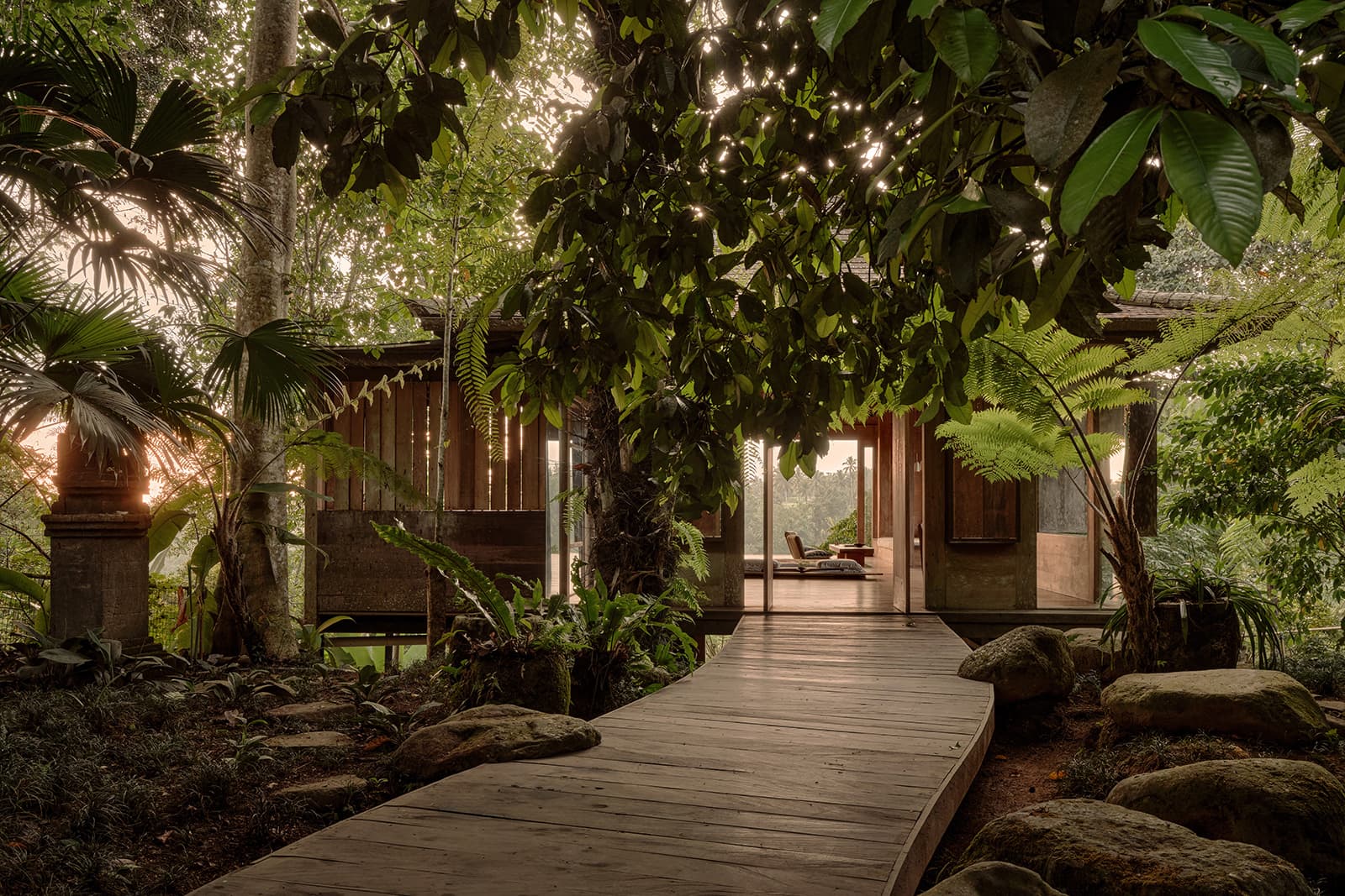 The wooden walkway leading to Kubu Sidem through the jungle canopy
